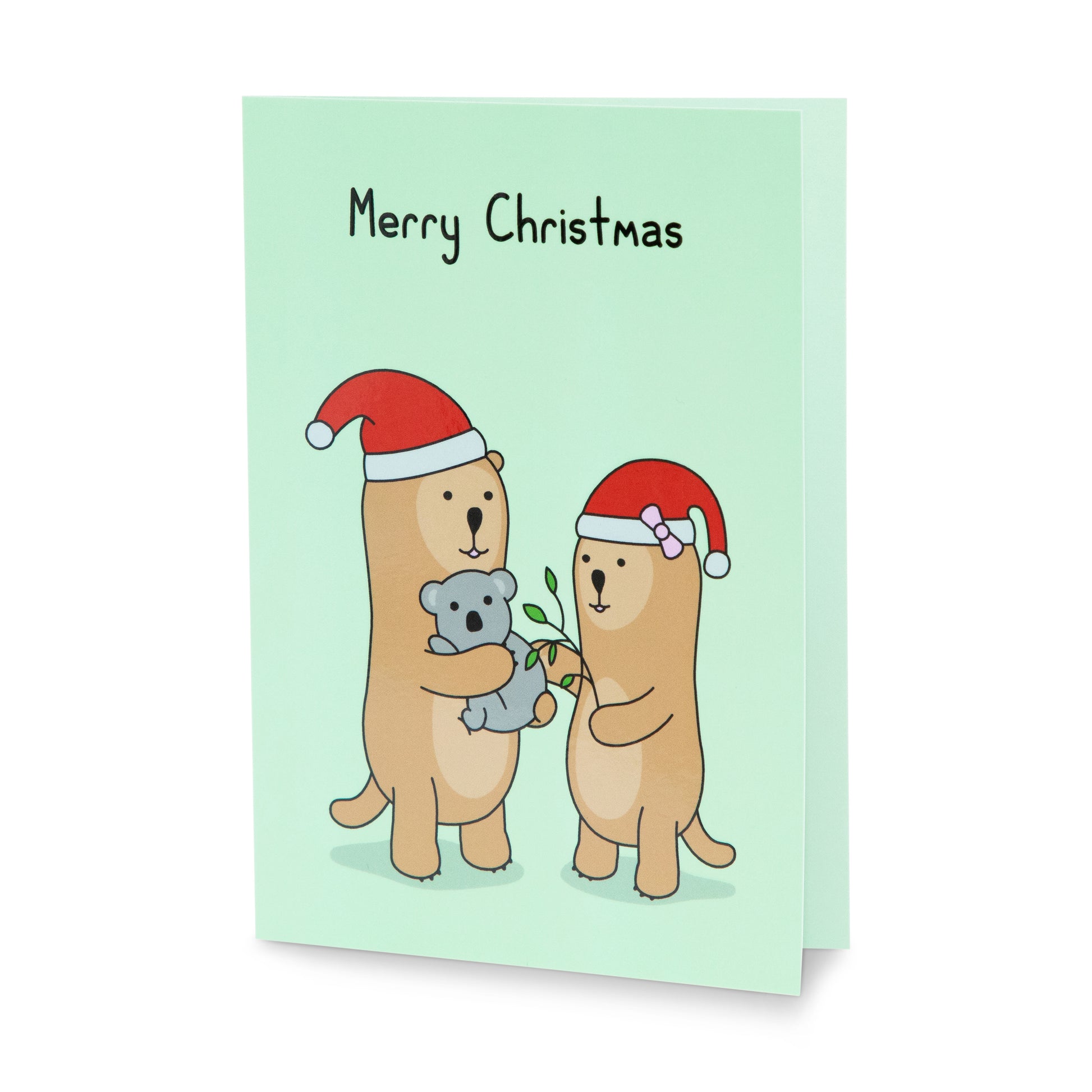 A green Christmas greeting card with a cheerful illustration of two otters in Santa hats, one is holding a koala, the other is feeding the koala leaves. The text on the card reads 'Merry Christmas'.