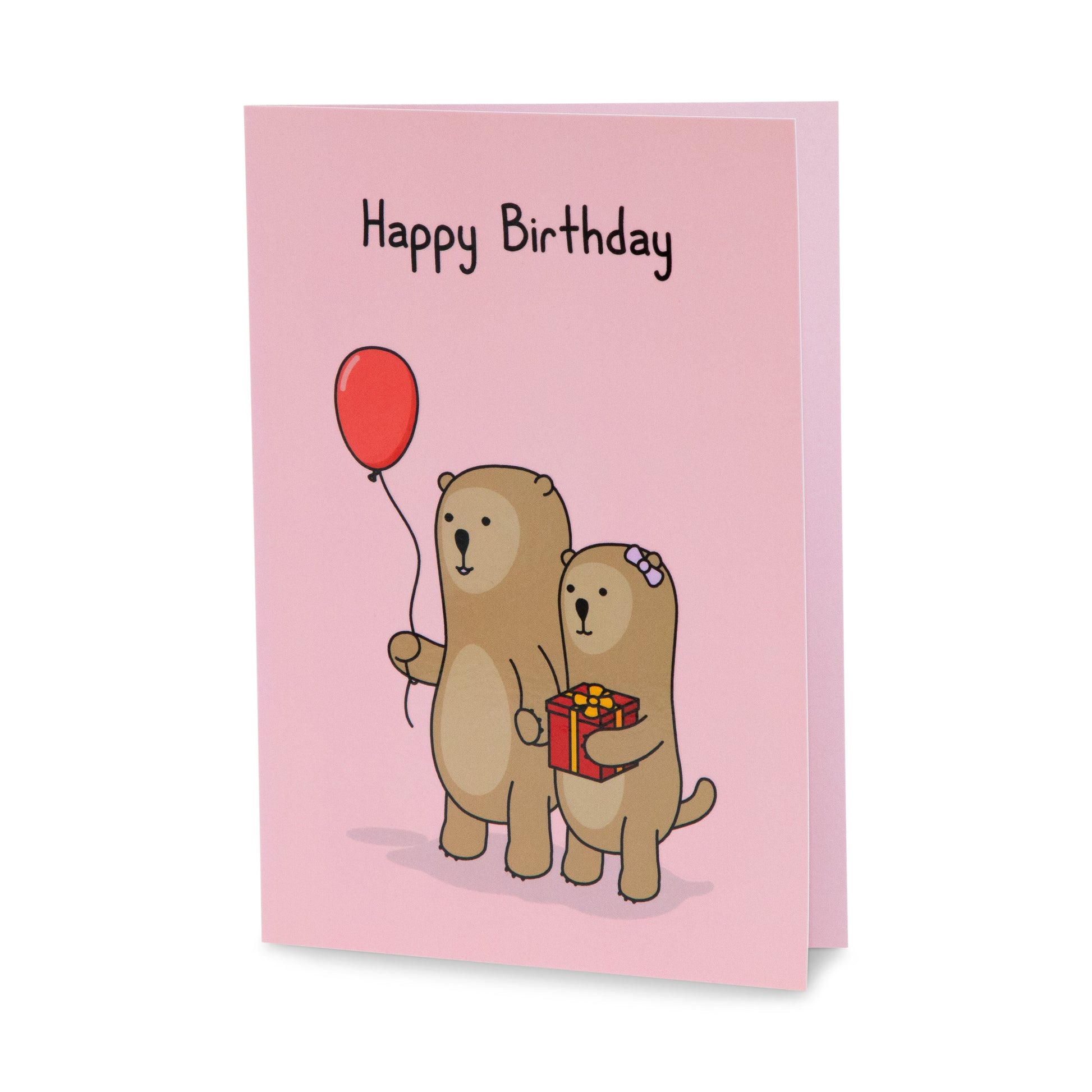 A red birthday greeting card with a cheerful illustration of otters going to a party one holding a balloon, the other holding a present. The text on the card reads 'Happy Birthday!'.