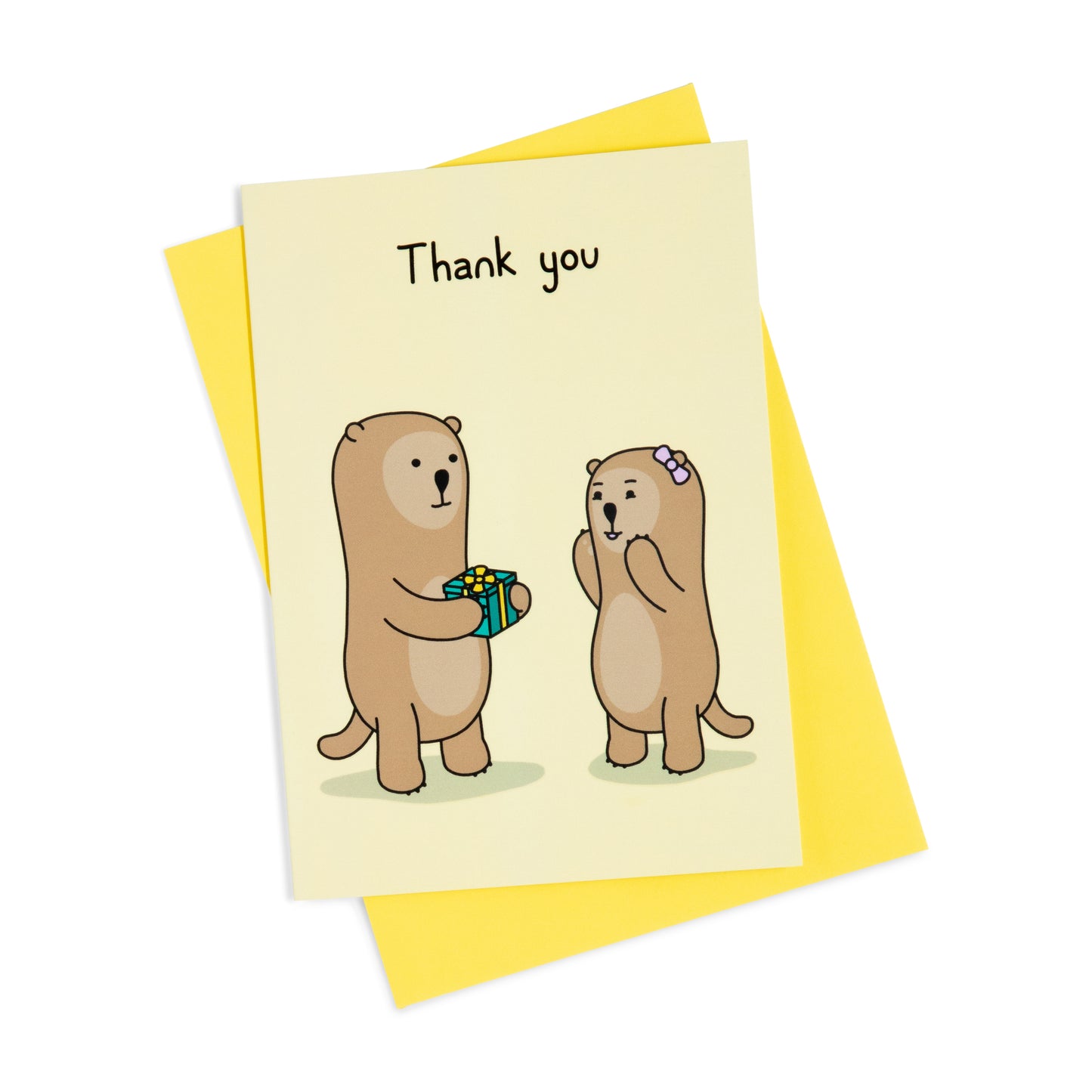 A yellow thank you greeting card with a cheerful illustration of one otter handing a green present to an exited otter. The text on the card reads 'Thank you'.